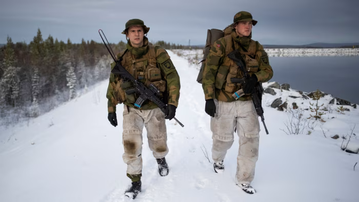 Patrol leader Joergen Aas (L) and radio operator Thomas Lundmann patrol the Norwegian side of the Norway-Russia border in Pasvik valley, Finnmark county, Norway