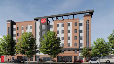 An image showing a large brick Salvation Army building under blue skies with cars in front in Atlanta. 