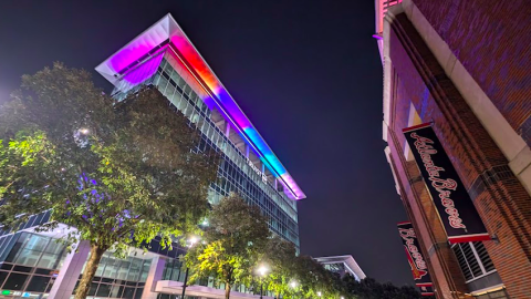 A photo of a new tower location outside the brick walls of the Atlanta Braves ballpark near wide streets. 